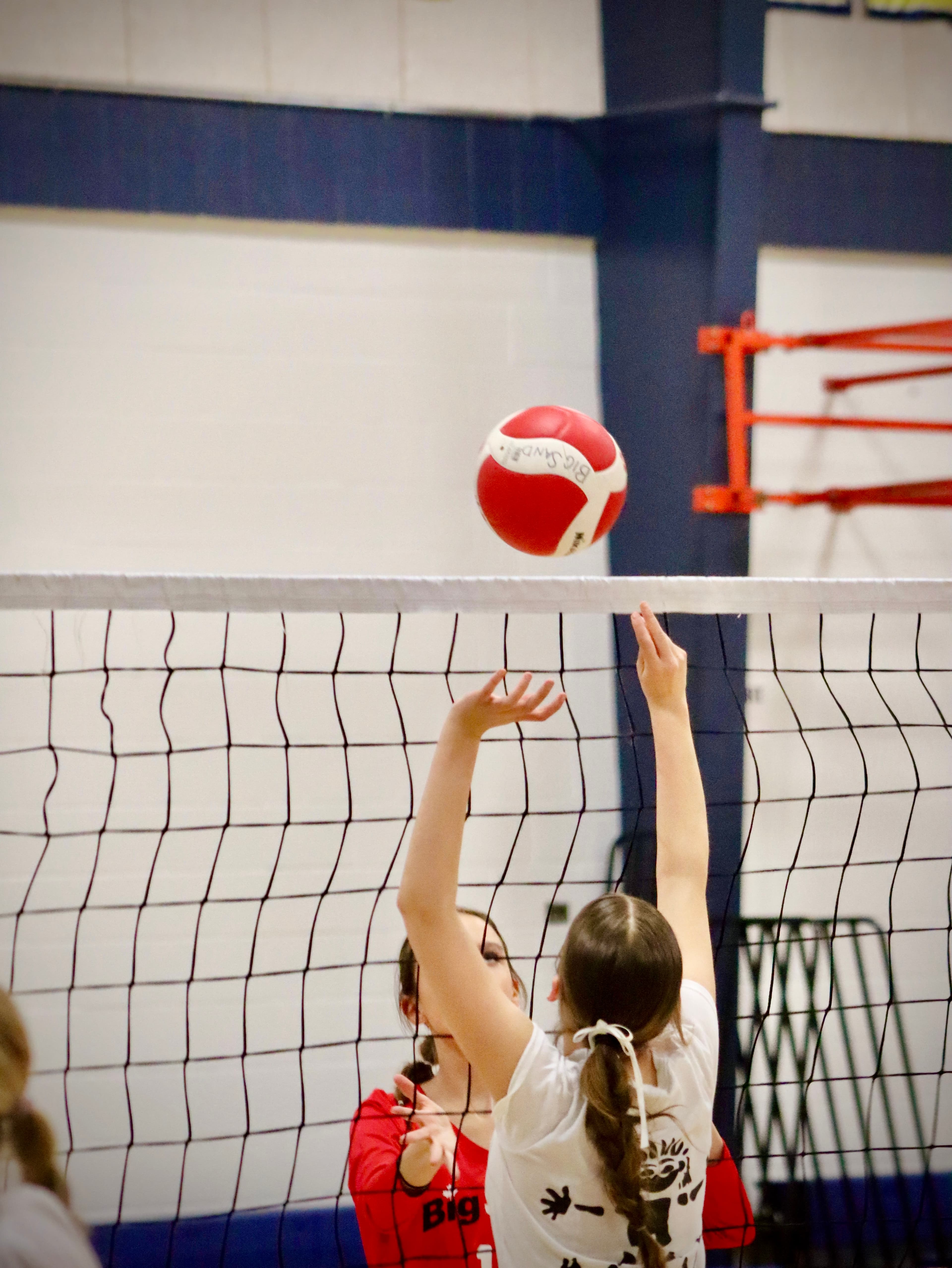 Volleyball player diving for a save on the sand